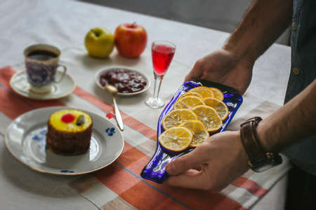 Only hands. Man finishing her plate and almost ready to serve at the table. Decoration of the table....