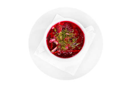 Borsch, beetroot, beetroot soup with seasoning, decorated with dill. On a napkin in a white plate...