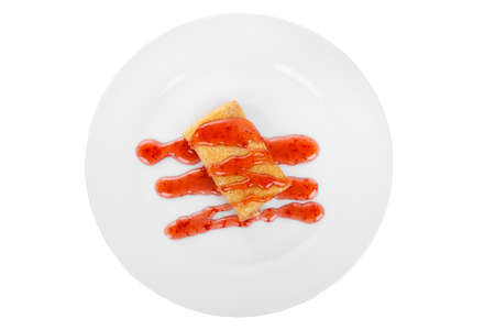 Pancake sweet stuffed with berry decoration, strawberry topping, on a plate isolated white background. Dessert for a menu in a cafe, restaurant, coffee shop view from aboveの写真素材