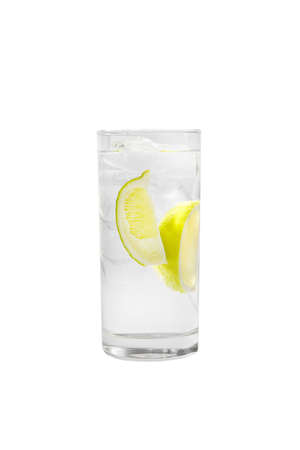 Transparent cocktail in a tall glass with ice cubes with two slices, lime quart, soda, aeration. Side view Isolated white background. Drink for the menu restaurant, bar, cafeの写真素材