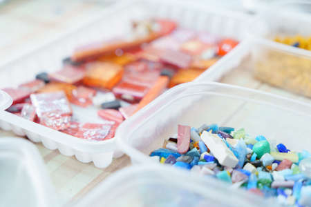 Containers with colored glass elements for mosaic - orange, red, pink, blue, for creativity artの写真素材