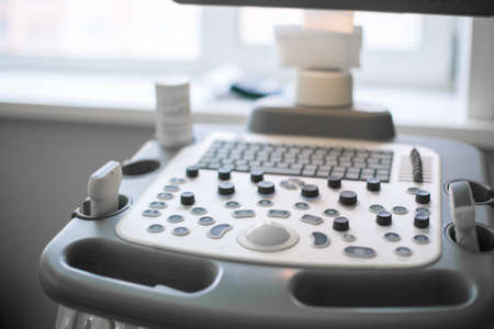 Close up in backlit high-tech ultrasound machine. Analysis, diagnosis of the condition of the disease using ultrasound scanningの写真素材