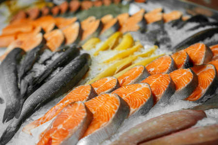 Close up of cooled seafood - trout, sockeye, sea bass, in the market of a fish shop, supermarket,...