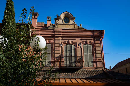 Tbilisi-Georgia- 19 - November - 2019. Beautiful windows in wooden blinds in an old building against a blue sky backgroundのeditorial素材