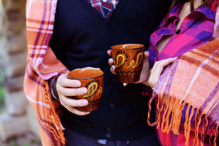 People are warmed by hot tea and a rugの写真素材