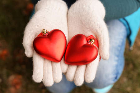 New Year's toys heart in the hands of a girl wearing glovesの写真素材