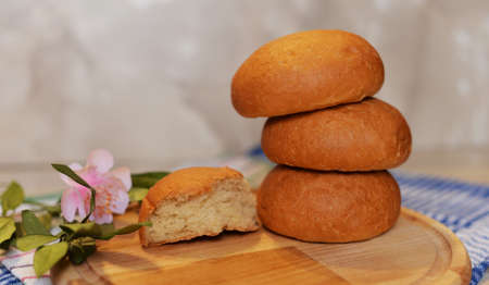 Beautiful aromatic bread with flowers on a wooden board