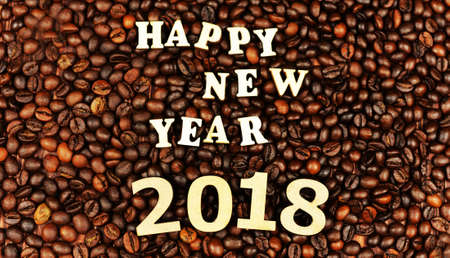 letters and numbers, inscription happy new year 2018 on coffee beans, background of coffeeの写真素材