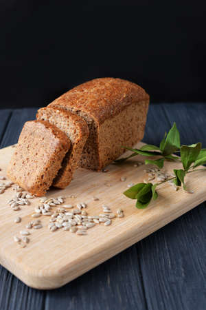 aromatic meal baking bread from dough on a wooden board on a beautiful background with plant leaves...
