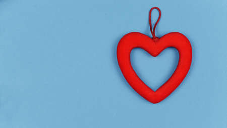 red heart decoration for the holiday of love Valentine's Day and wedding on a blue backgroundの写真素材