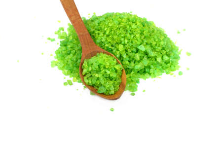 green sea salt for spa treatments and health on a wooden spoon on a white isolated backgroundの写真素材
