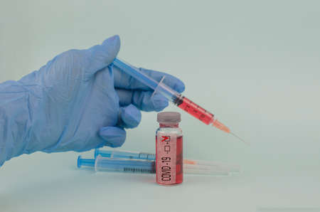 test with coronovirus in epidemic with test tube and syringe with a blood test in the labの写真素材