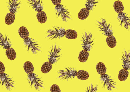 tropical pattern with exotic pineapple fruit on a yellow backgroundの写真素材
