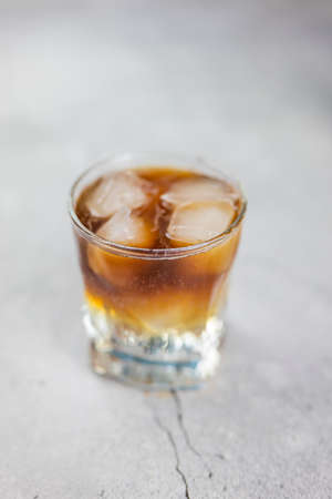 cocktail drink alcoholic whiskey cola in glass on gray background