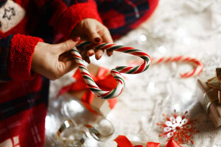 girl holding santa claus heart shaped candy for new year and christmasの写真素材
