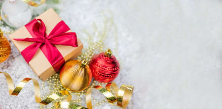 panorama New Year's decor with decorations balls on a Christmas tree with serpentine and gift boxes,...
