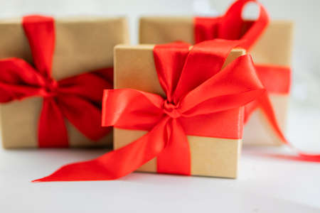beautiful festive surprise gift box with a red bow on a bokeh background  for new year and valentine's dayの写真素材