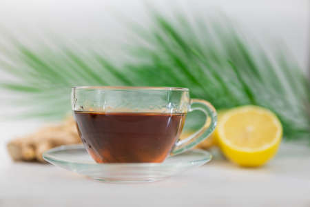 hot black drink tea in a cup with lemon and gingerの写真素材