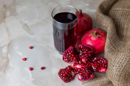 delicious healthy fruit pomegranate red with juice in a glassの写真素材