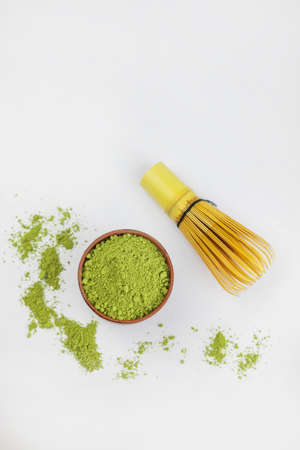 dry powder green tea japanese with bamboo whisk on white backgroundの写真素材