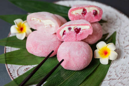 delicious japanese cuisine dessert mochi pink brownies with butter cream and currants with bumbu leavesの写真素材