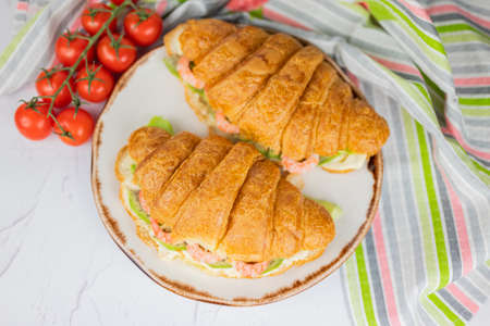 breakfast with food croissant roll with lettuce and shrimps.の写真素材