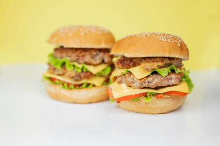 burger sandwich hamburger with vegetables meat cutlet on yellow background