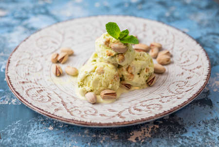 pistachio ice cream balls on a plate in a restaurantの写真素材