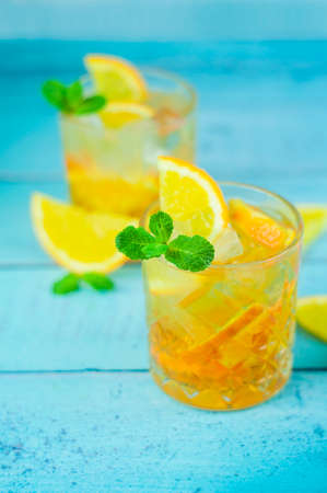 delicious refreshing cocktail drink with alcohol and orange with mint leafの写真素材