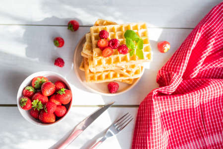 delicious Belgian waffles with strawberries and raspberriesの写真素材