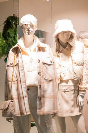 mannequins on display in a store with clothes in a shopping center