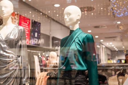 mannequins on display in a store with clothes in a shopping centerの写真素材
