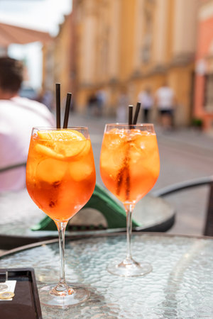 two alcoholic drinks cocktail aperol spritzer on the summer terrace in the restaurantの写真素材