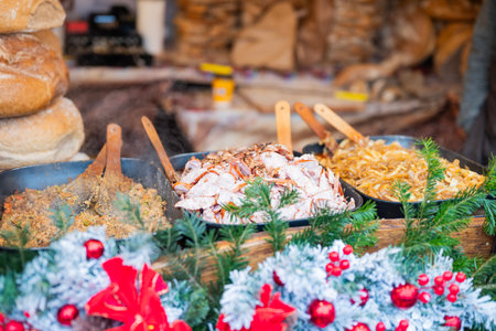 vendor fries meat and sausage on the grill in the city center at the Christmas market in Krakow Polandの写真素材
