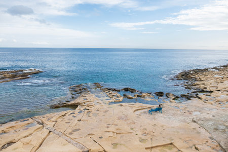 A beautiful seashore with rocks and waves in the city of Sliema, Maltaの写真素材