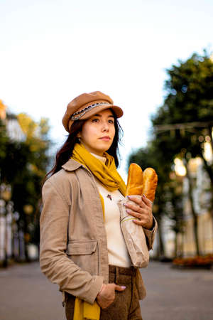 A young woman with long hair walks around the city