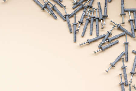 a group of dowels and nails on a yellow background,free space, space for textの写真素材