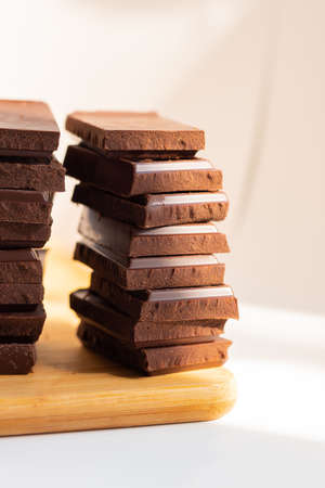 World Chocolate Day pieces of chocolate on a wooden board.の写真素材