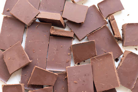 background of chocolate pieces on a white background.