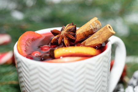 mulled wine drink in a white mug, concept holiday Christmas anise cinnamon orange cranberry.の写真素材