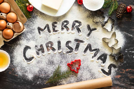 ingredients for Christmas gingerbread.molds, eggs, butter, sugar.the inscription merry christmasの写真素材