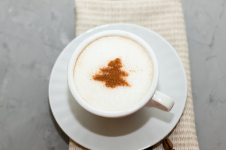cappuccino coffee cup with cinnamon pattern, christmas drink,on concrete backgroundの写真素材