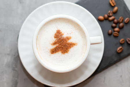cappuccino coffee cup with cinnamon pattern, christmas drink,on concrete backgroundの写真素材