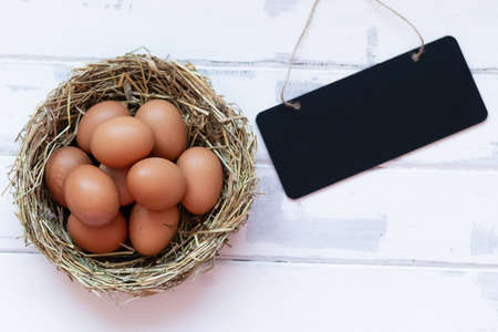 eggs in a nest on a white background,a place to copy, a place for a price or text, top viewの写真素材