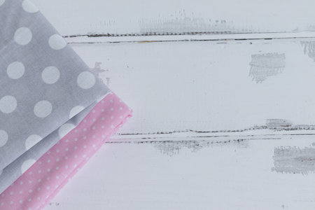 Close-up of cotton fabric. Cotton fabric laid in layers on a white background. Natural fabric for...