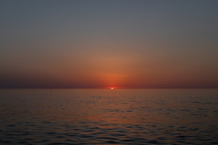 sunset on the background of the sea sky, Sunset sky, clouds over the sea in the evening with orange, yellow sunlight, Golden hour.の写真素材