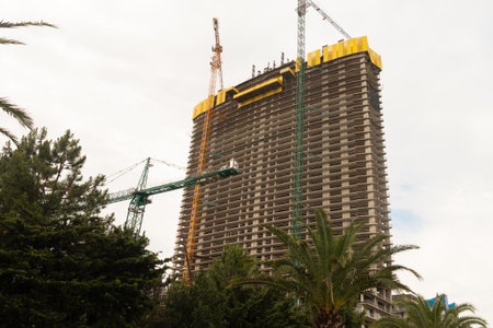 unfinished high-rise building on the embankment. A multi-storey hotel under construction.