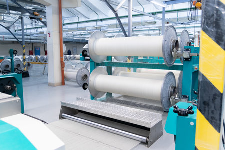Industrial fabric production line. Looms in a textile factory.