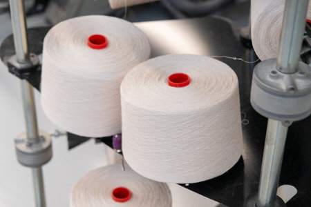 large bobbins of thread in a weaving factory.