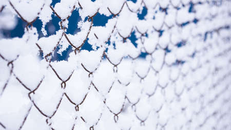 Grid fence in the snow. a lot of snow on the iron fenceの写真素材